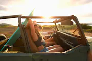 Two people drive around in a Jeep.