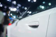 A close-up image of a white car door.