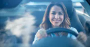 young-woman-driving-hands-on-wheel