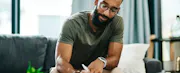 A black man signs loan paperwork.